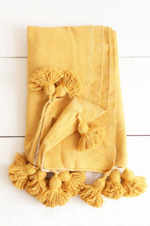 moroccan throw with pompoms available at baba souk