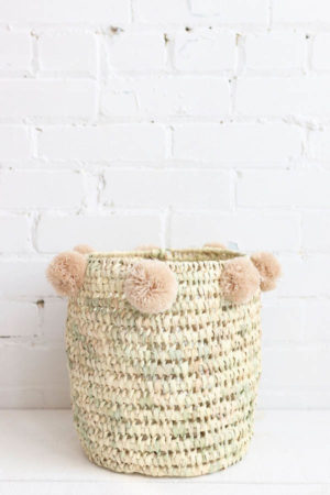 basket with pompoms made of natural wicker. Handmade in Marrakech