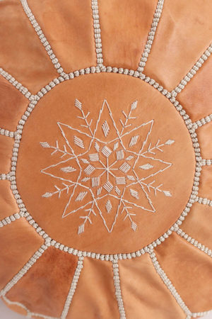 moroccan pouf in tan leather available at baba souk