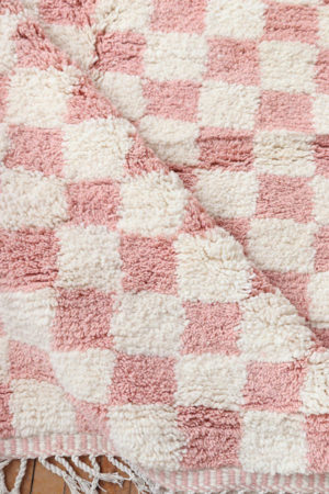 pink checkered wool rug available at baba souk